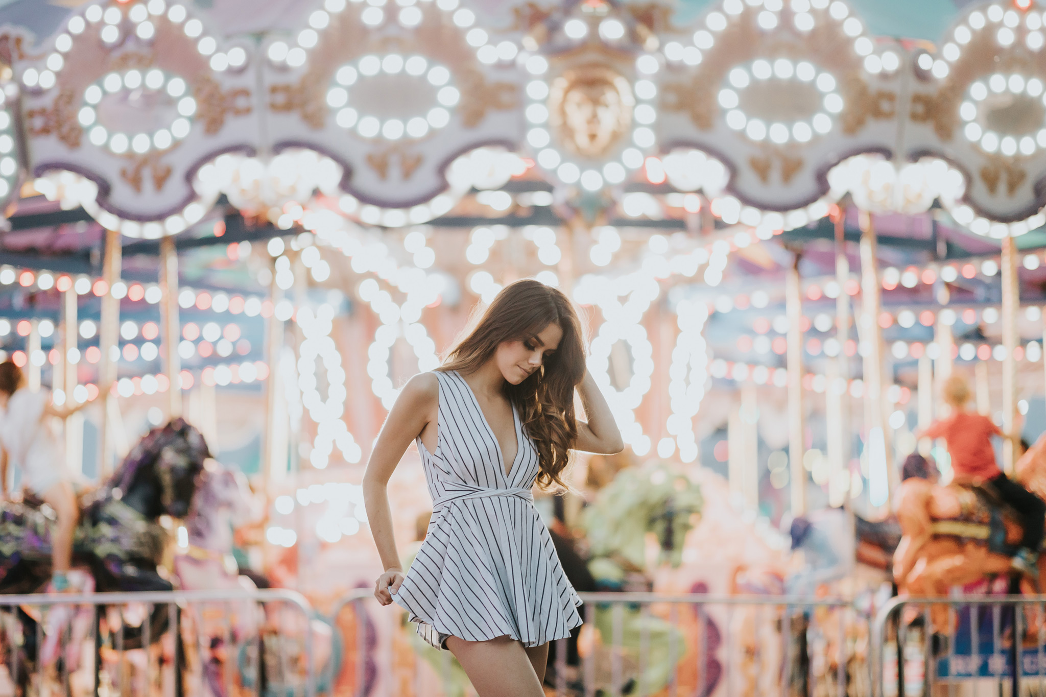 model posing in front of carousel lights stampede midway alberta